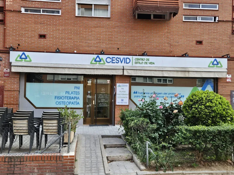 Fachada de CESVID en la calle del Pico Balaitus, 40: rótulo blanco con el logo, toldo y escaparates con los cuatro servicios